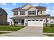 Two-story house with a neutral color scheme, stone accents, and a two-car garage at 4168 Dutton Dr, Bargersville, IN 46106
