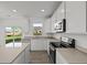 Modern kitchen with white cabinets, stainless steel appliances, and access to backyard at 4168 Dutton Dr, Bargersville, IN 46106