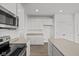 Modern kitchen with white cabinets, stainless steel appliances, and light countertops at 4168 Dutton Dr, Bargersville, IN 46106