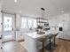 Modern kitchen with white cabinetry, quartz countertops, and island at 7284 County Road 600 W, McCordsville, IN 46055