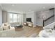 Open living room with off-white couch and a view to dining area at 7284 County Road 600 W, McCordsville, IN 46055