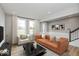 Spacious living room with a leather couch and large windows at 7284 County Road 600 W, McCordsville, IN 46055