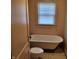 Bathroom with clawfoot tub, toilet, and window at 3033 Forest Manor Ave, Indianapolis, IN 46218