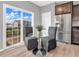 Bright kitchen nook features glass table, chairs, and sliding glass door leading to deck at 7244 Birch Leaf Dr, Indianapolis, IN 46259