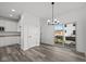 Bright dining room with gray flooring and a chandelier, adjacent to the kitchen at 4190 Douro Trl, Westfield, IN 46062