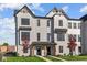 Modern 2-story townhome with gray siding, black windows, and a landscaped front yard at 4190 Douro Trl, Westfield, IN 46062