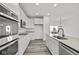 Modern kitchen with white cabinets, stainless steel appliances, and a large island at 4190 Douro Trl, Westfield, IN 46062