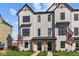 Modern 2-story townhome with gray siding, black windows, and a landscaped front yard at 4190 Douro Trl, Westfield, IN 46062