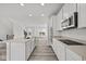 Open-concept kitchen with white cabinets, island, and stainless steel appliances at 4190 Douro Trl, Westfield, IN 46062