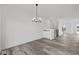 Open dining area with hardwood floors and a modern chandelier at 4190 Douro Trl, Westfield, IN 46062