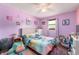 Purple bedroom with LVP flooring, featuring a bed and various decorations at 5631 N Olivia Dr, Alexandria, IN 46001