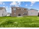 Two story house with brown siding, backyard view and patio at 10207 Carya Ct, Indianapolis, IN 46259