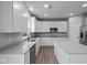 Modern kitchen with white cabinets, stainless steel appliances and an island at 10207 Carya Ct, Indianapolis, IN 46259