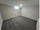 Spacious basement bedroom with grey carpeting and a window at 5531 Maplewood Dr, Indianapolis, IN 46224