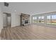 Finished basement with hardwood floors, stone fireplace, and large windows at 4988 Amber Crest Dr, Brownsburg, IN 46112