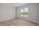 Bright bedroom with large window and light brown wood-look flooring at 4988 Amber Crest Dr, Brownsburg, IN 46112