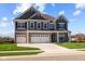 Two-story home with gray siding, white trim, and a three-car garage at 4988 Amber Crest Dr, Brownsburg, IN 46112