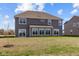 Two-story house with gray siding, sunroom, and grassy backyard at 4988 Amber Crest Dr, Brownsburg, IN 46112