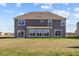 Two-story house with gray siding, sunroom, and grassy backyard at 4988 Amber Crest Dr, Brownsburg, IN 46112