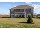 Two-story house with gray siding, sunroom, and grassy backyard at 4988 Amber Crest Dr, Brownsburg, IN 46112