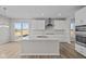 Modern kitchen with white cabinets, island, and stainless steel appliances at 4988 Amber Crest Dr, Brownsburg, IN 46112