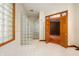Bathroom with glass block shower and wooden doors leading to another room at 12980 W Mt. Healthy Rd, Columbus, IN 47201