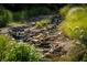 Serene landscape featuring a natural stone waterfall at 12980 W Mt. Healthy Rd, Columbus, IN 47201