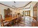 Open dining room with hardwood floors, large windows, and wood accents at 12980 W Mt. Healthy Rd, Columbus, IN 47201