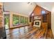 Gathering room with hardwood floors, a fireplace, and large windows at 12980 W Mt. Healthy Rd, Columbus, IN 47201
