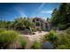 Stone house exterior with a large patio, fire pit, and pond at 12980 W Mt. Healthy Rd, Columbus, IN 47201