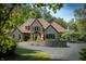 Stone house with landscaping and driveway at 12980 W Mt. Healthy Rd, Columbus, IN 47201