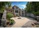 Landscaped backyard patio with fire pit and stone retaining wall at 12980 W Mt. Healthy Rd, Columbus, IN 47201
