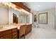 Spa-like bathroom with double vanity, glass block windows, and a shower at 12980 W Mt. Healthy Rd, Columbus, IN 47201