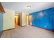 Spacious bedroom with blue accent wall and carpeting at 12980 W Mt. Healthy Rd, Columbus, IN 47201
