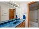 Bathroom with blue granite vanity, large mirror, and shower at 12980 W Mt. Healthy Rd, Columbus, IN 47201