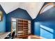 Sunlit office with blue walls, built-in shelves, and hardwood floors at 12980 W Mt. Healthy Rd, Columbus, IN 47201