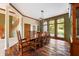 Formal dining room with hardwood floors, large windows, and wood furniture at 12980 W Mt. Healthy Rd, Columbus, IN 47201