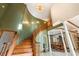 Grand wooden staircase with chandelier and columns at 12980 W Mt. Healthy Rd, Columbus, IN 47201