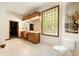 Elegant bathroom with double vanity, large mirror, and glass block window at 12980 W Mt. Healthy Rd, Columbus, IN 47201