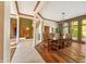 Bright dining room with hardwood floors, large windows, and a wood table at 12980 W Mt. Healthy Rd, Columbus, IN 47201