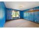 Bedroom featuring a window, blue walls, and wood trim at 12980 W Mt. Healthy Rd, Columbus, IN 47201