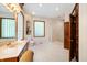 Bathroom with double vanity, glass block windows and a shower at 12980 W Mt. Healthy Rd, Columbus, IN 47201
