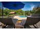 Stunning pool with lounge chairs and blue umbrella at 12980 W Mt. Healthy Rd, Columbus, IN 47201