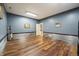 Spacious basement room with wood floors and metal wall accents at 12980 W Mt. Healthy Rd, Columbus, IN 47201
