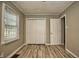 Spacious bedroom with double door closet and wood-look flooring at 3438 N Leland Ave, Indianapolis, IN 46218