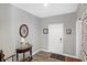 Bright entryway with wood-look floors, a console table, and mirror at 8711 Faulkner Dr, Indianapolis, IN 46239