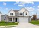 Two-story home with gray siding, white accents, and a two-car garage at 10206 Carya Ct, Indianapolis, IN 46259