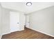 Well-lit bedroom with wood-look floors and access to hallway at 215 N Randolph St, Indianapolis, IN 46201