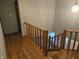 Upstairs hallway with wood floors and wooden railing at 8530 Applewood Ln, Indianapolis, IN 46256