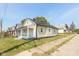 Charming yellow house with gray porch and well-maintained lawn at 728 E Beecher St, Indianapolis, IN 46203